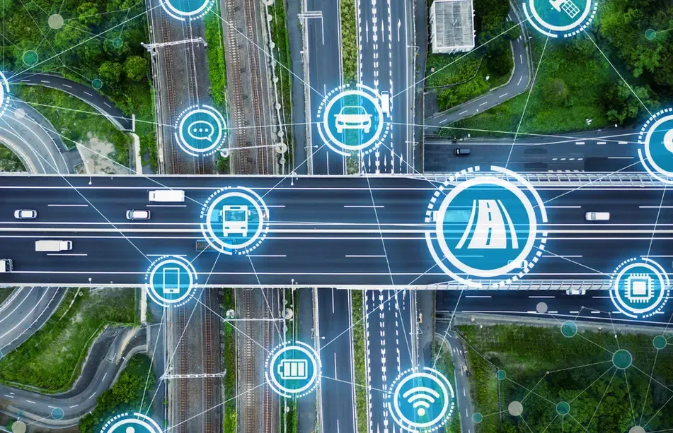 An aerial view of a highway and railway intersection with digital icons for connectivity, highlighting Geosecure's telematics solutions.