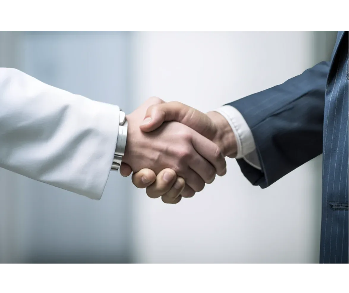 A close-up of a handshake between a person in a white coat and another in a business suit, symbolizing partnership and collaboration. 