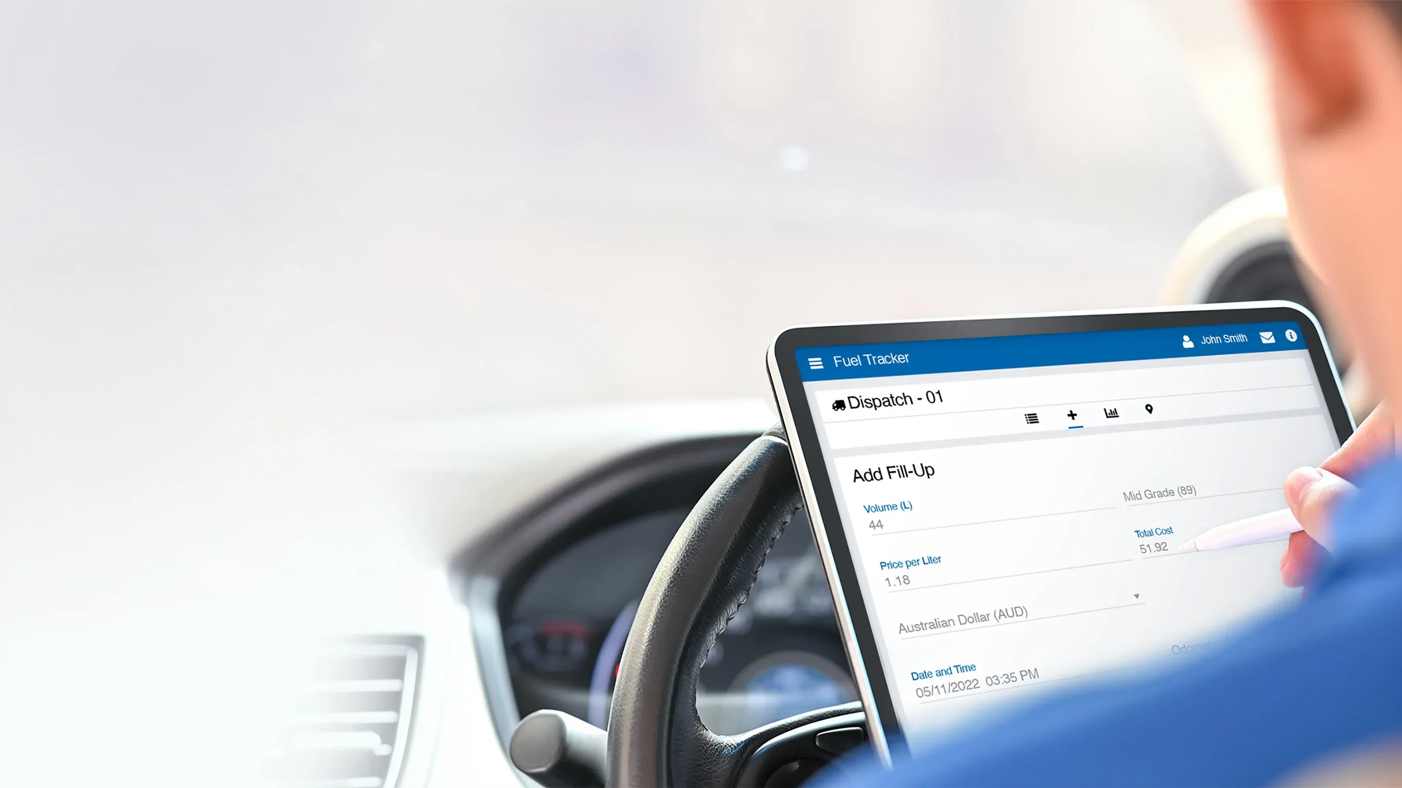 A person using a tablet inside a vehicle, accessing a fuel tracker application to monitor and log fuel data for ''Dispatch 01.''